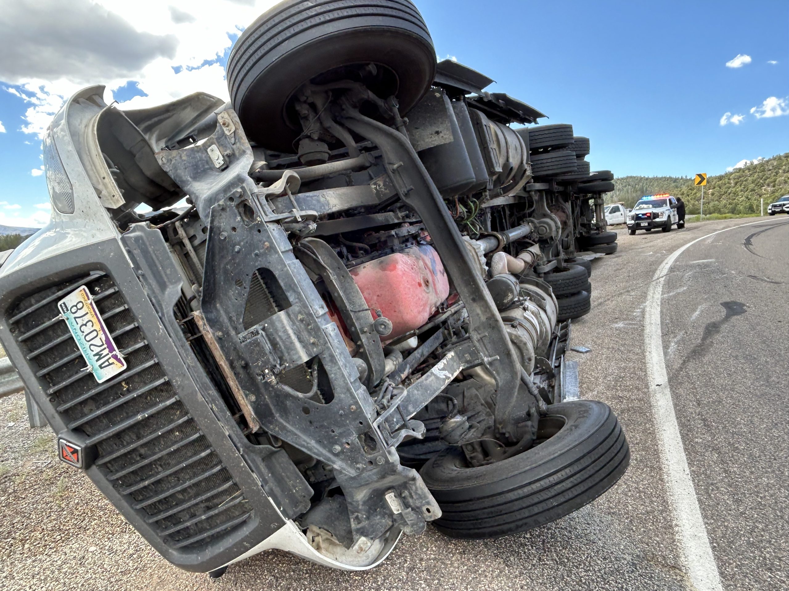 Semi loaded with bags of dry concrete mix tips over in Iron County